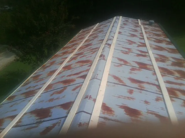 Rusted metal roof panels with new wood purlins before replacement — Storm Damage Roof Repair in Pottsboro by Roofing Brothers