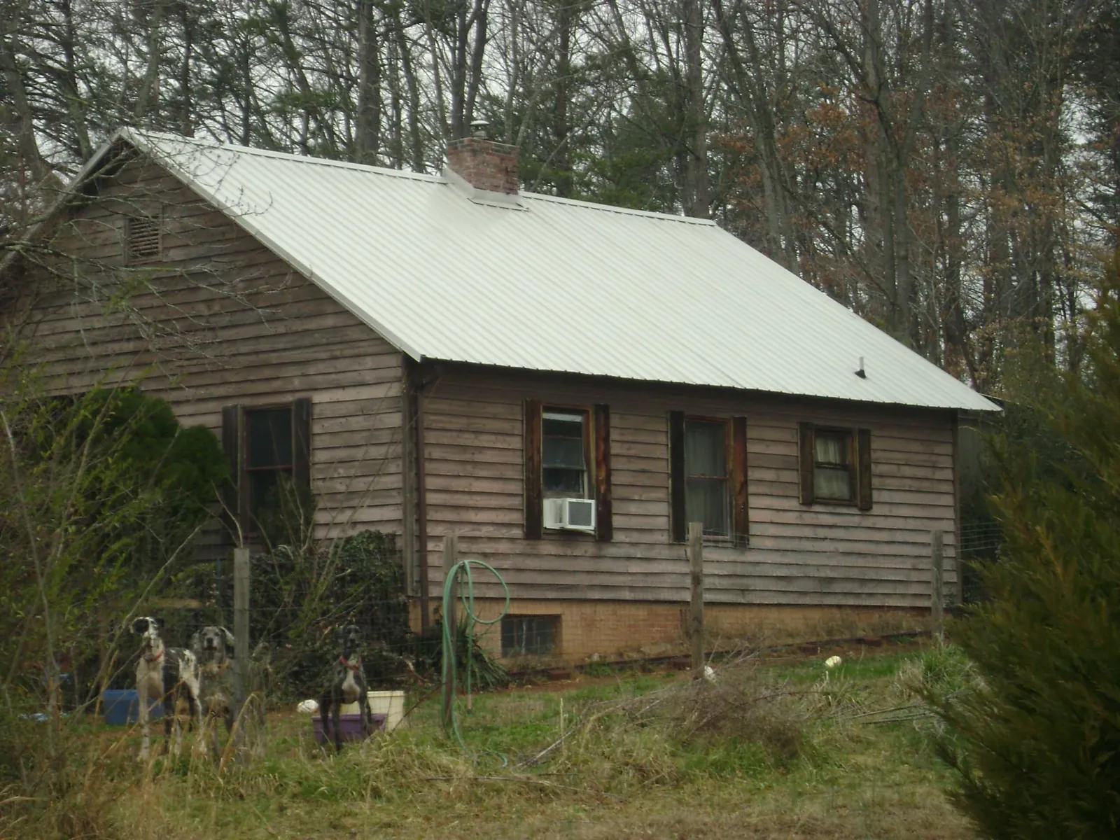 White metal roof on an old wood sided farmhouse, from a Metal Roof Installation job in Pottsboro
