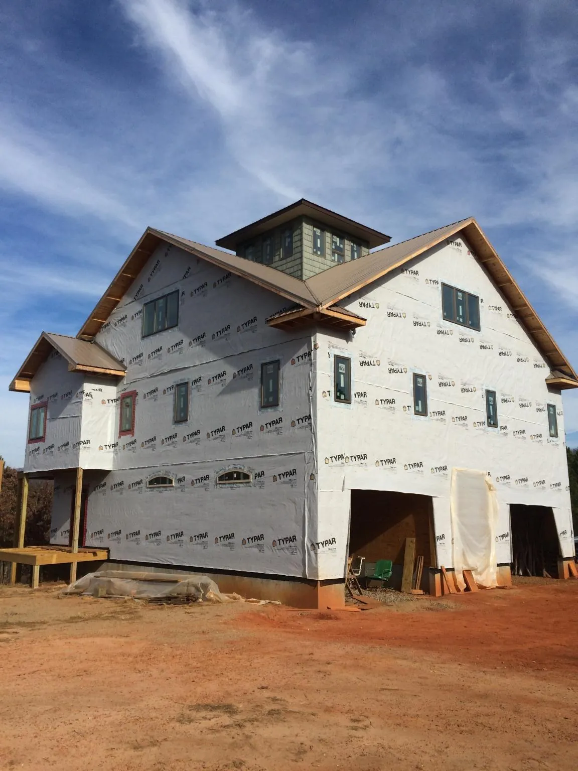 New two story house under construction with a cupola and gabled roofs in Pottsboro